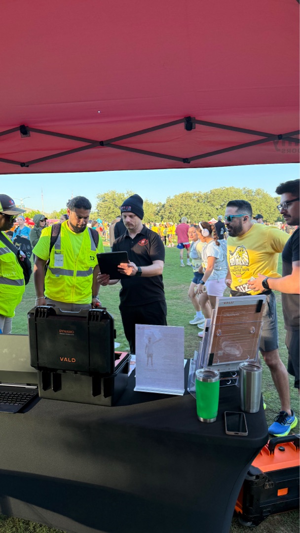 Trey running a VALD HumanTrak assessment for a runner at the Sunshine Run